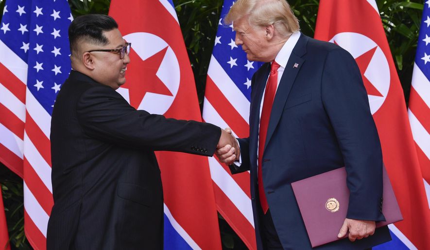 FILE - In this June 12, 2018 file photo, North Korea leader Kim Jong Un and U.S. President Donald Trump shake hands at the conclusion of their meetings at the Capella resort on Sentosa Island in Singapore. The newly appointed U.S. special envoy for North Korea will make his first diplomatic trip abroad next week in the Trump administration’s latest effort to press for progress in uncertain denuclearization talks. (AP Photo/Susan Walsh, Pool)