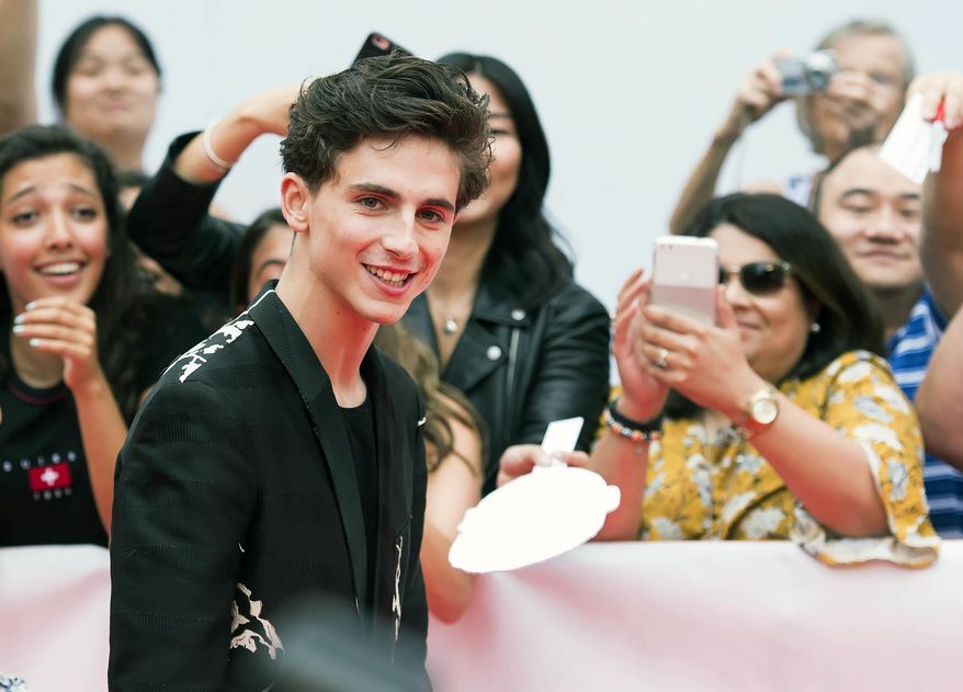 Actor Timothee Chalamet poses for photographs on the red carpet after arriving for the new movie "Beautiful Boy" during the 2018 Toronto International Film Festival, Friday, Sept. 7, 2018 in Toronto. (Nathan Denette/The Canadian Press via AP)