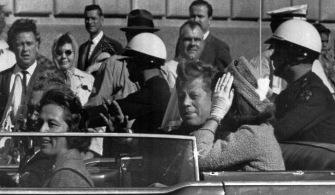 In this Nov. 22, 1963 file photo, President John F. Kennedy rides in a motorcade with his wife Jacqueline moments before he was shot and killed in Dallas. Texas Governor and Mrs. John Connally are also in the car. Video footage of Kennedy&#x27;s motorcade as it drove slowly through Dallas marked an entire generation and has been the source of plenty of conspiracy theories since. (AP Photo, File)  **FILE**