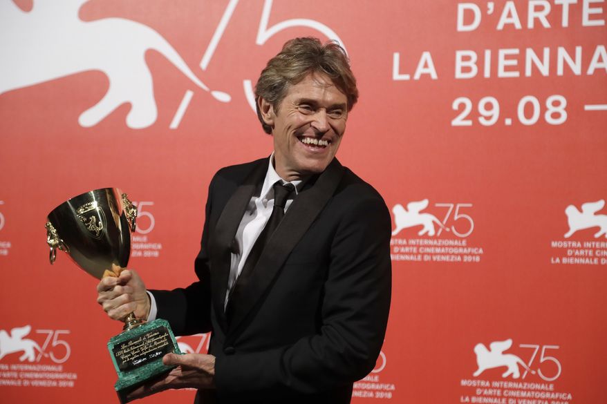 Actor Willem Dafoe holds the Coppa Volpi Best Actor award for 'At Eternity's Gate' at the awards photo call of the 75th edition of the Venice Film Festival in Venice, Italy, Saturday, Sept. 8, 2018. (AP Photo/Kirsty Wigglesworth)