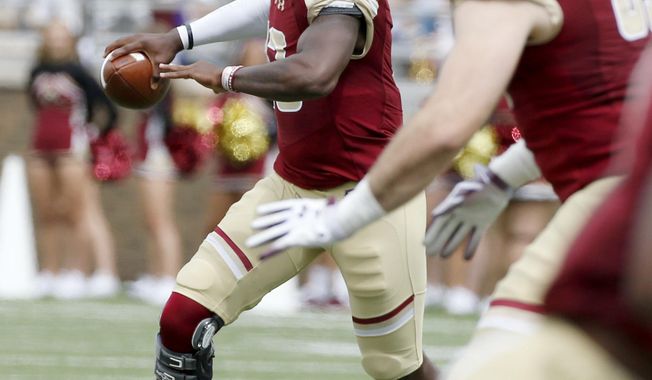 Boston College quarterback Anthony Brown (13) scrambles as he looks to pass during the first half of an NCAA college football game against Holy Cross, Saturday, Sept. 8, 2018, in Boston. (AP Photo/Mary Schwalm)