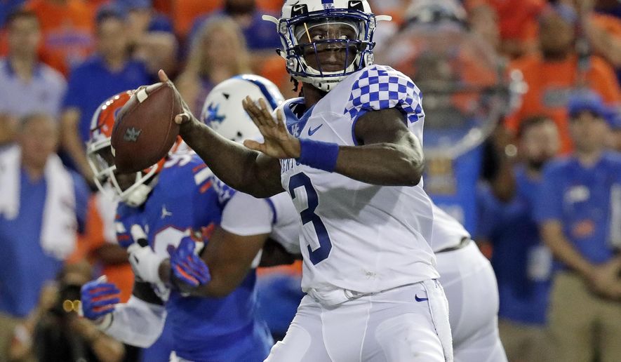 Kentucky quarterback Terry Wilson (3) looks for a receiver as he is pressured by the Florida defense during the first half of an NCAA college football game, Saturday, Sept. 8, 2018, in Gainesville, Fla. (AP Photo/John Raoux)