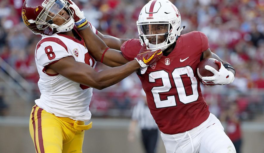 Stanford running back Bryce Love (20) stiff-arms Southern California cornerback Iman Marshall (8) during the first half of an NCAA college football game, Saturday, Sept. 8, 2018, in Stanford, Calif. (AP Photo/Tony Avelar)