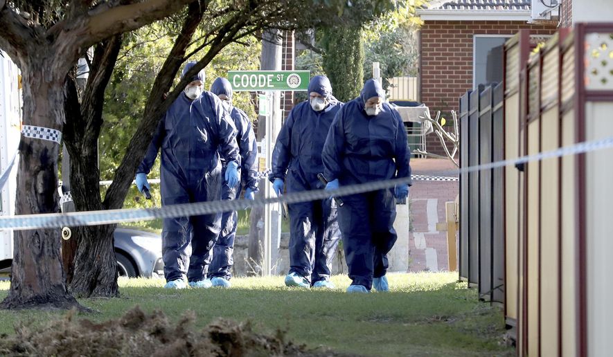 In this Sunday, Sept. 9, 2018 photo, forensic police officers inspect a property in suburban Perth, Australia. Three children, their mother and grandmother have been found dead in a house after a man alerted police, detectives said Monday. (AAP Image/Richard Wainwright)