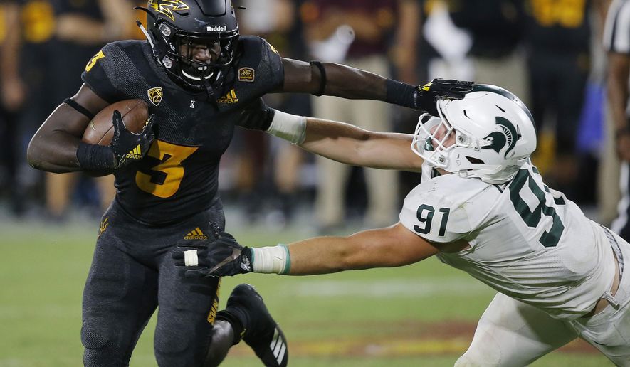 Arizona State running back Eno Benjamin (3) gives Michigan State defensive end Jack Camper (91) a stiff arm as he tries to get past during the second half of an NCAA college football game Saturday, Sept. 8, 2018, in Tempe, Ariz. Arizona State defeated Michigan State 16-13. (AP Photo/Ross D. Franklin)