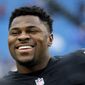 FILE - In this Oct. 29, 2017, file photo, Oakland Raiders defensive end Khalil Mack smiles before an NFL football game against the Buffalo Bills in Orchard Park, N.Y. The Rams and Oakland Raiders spent most of the lead up to the season in the same predicament, with their former Defensive Players of the Year holding out while seeking new contracts. When the teams open the season against each other Monday, Sept. 10, in Oakland, that will have changed. Aaron Donald will line up for the Rams, while the Raiders traded Mack to Chicago. (AP Photo/Jeffrey T. Barnes, File)