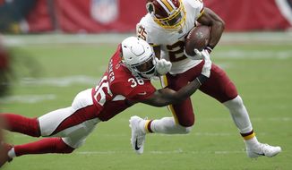 Washington Redskins running back Chris Thompson (25) is hit by Arizona Cardinals defensive back Budda Baker (36) during the first half of an NFL football game, Sunday, Sept. 9, 2018, in Glendale, Ariz. (AP Photo/Ross D. Franklin) ** FILE **
