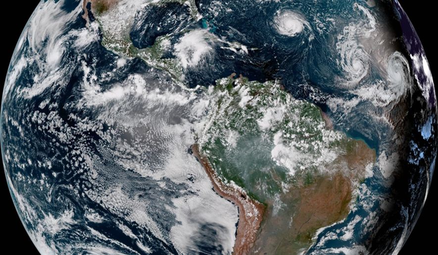 This enhanced satellite image provided by NOAA shows Hurricane Florence, third from right, in the Atlantic Ocean on Sunday, Sept. 9, 2018. At right is Tropical Storm Helene, and second from right is Tropical Storm Isaac. (NOAA via AP)
