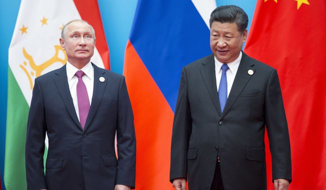 Chinese President Xi Jinping (right) and Russian President Vladimir Putin pose for a photo at the Shanghai Cooperation Organization (SCO) Summit in Qingdao in eastern China&#x27;s Shandong Province. (AP Photo/Alexander Zemlianichenko, File)