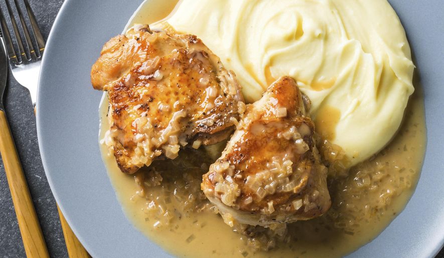 This undated photo provided by America's Test Kitchen in August 2018 shows pan-roasted chicken breasts with shallot-thyme sauce in Brookline, Mass. This recipe appears in the cookbook “How to Roast Everything.” (Joe Keller/America's Test Kitchen via AP)
