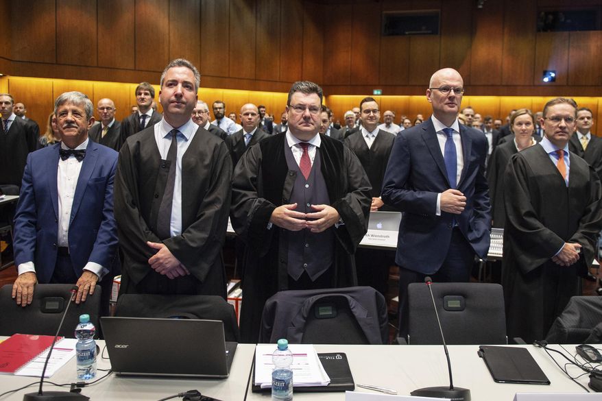 Andreas W. Tilp, lawyer of the plaintiff, waits for the opening of a lawsuit against Volkswagen on compensation for the losses of shareholders caused by the Diesel scandal at the higher regional court in Braunschweig, northern Germany, Monday, Sept. 10, 2018. (Swen Pfoertner/dpa via AP)