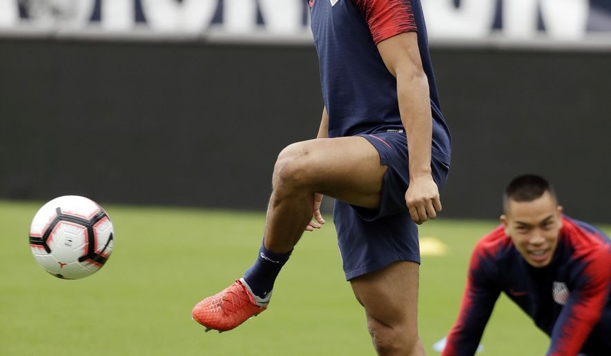 United States men&#39;s national soccer team left back Antonee Robinson, left, warms up during a practice Monday, Sept. 10, 2018, in Nashville, Tenn. The U.S. Men&#39;s National Team is scheduled to play Mexico in an international friendly match Tuesday. (AP Photo/Mark Humphrey)