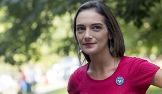 FILE - In this Wednesday, Aug. 15, 2018 file photo, Democratic New York state Senate candidate Julia Salazar smiles as she speaks to a supporter before a rally in McCarren Park in the Brooklyn borough of New York. Salazer said Tuesday, Sept. 11. 2018 that she was sexually assaulted five years ago by David Keyes , a spokesman for Israeli Prime Minister Benjamin Netanyahu, an accusation the man denies. (AP Photo/Mary Altaffer, File)