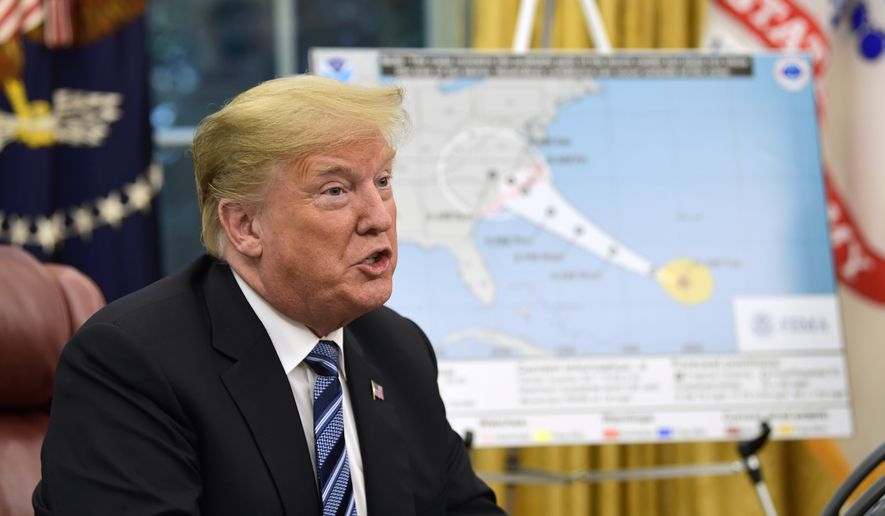 President Donald Trump talks about Hurricane Florence during a briefing in the Oval Office of the White House in Washington, Tuesday, Sept. 11, 2018. (AP Photo/Susan Walsh)
