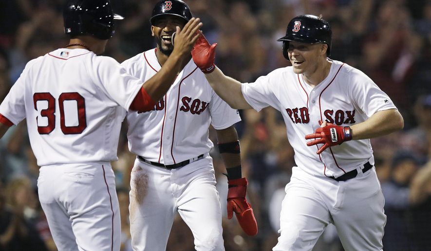 Boston Red Sox&#39;s Brock Holt, right, celebrates with Tzu-Wei Lin (30) and Eduardo Nunez, center, after his pinch-hit, three-run home run off Toronto Blue Jays relief pitcher Ryan Tepera during the seventh inning of a baseball game at Fenway Park in Boston, Tuesday, Sept. 11, 2018. (AP Photo/Charles Krupa)