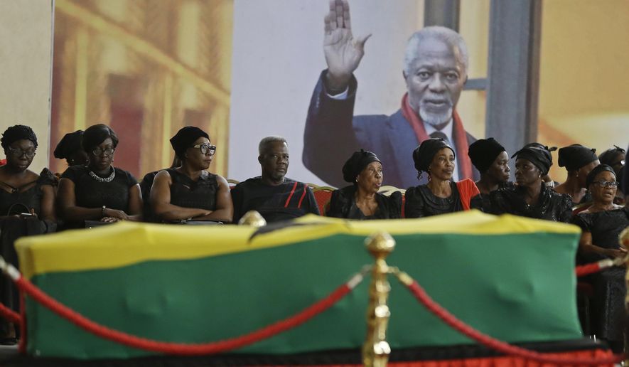 Members of the public pay their respects as the coffin of former U.N. Secretary-General Kofi Annan lies in state at the Accra International Conference Center in Ghana Tuesday, Sept. 11, 2018. Ghanaians are paying their respects to Annan, who died in August in Switzerland at age 80, ahead of Thursday's state funeral. (AP Photo/Sunday Alamba)