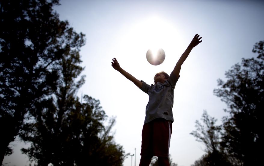 In this Sept. 8, 2018 photo, Candelaria Cabrera plays with a soccer ball in Chabaz, Argentina. "Cande," as she is known by friends and family, is the only girl playing in a children's soccer league in the southern part of Argentina's Santa Fe province, birthplace of stars including Lionel Messi, Gabriel Batistuta and Jorge Valdano. (AP Photo/Natacha Pisarenko)