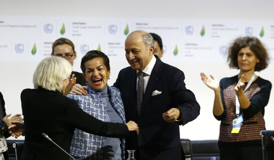 FILE - In this Dec. 12, 2015 file photo, French foreign minister and President of the COP21 Laurent Fabius, center, hugs France's Laurence Tubiana, special representative for the COP21, left, and United Nations climate chief Christiana Figueres after the final conference of the COP21, the United Nations conference on climate change, in Le Bourget, north of Paris. The international effort to fight climate change is about to get injected with a bit of Hollywood flash, a lot of Wall Street green and a considerable dose of cheerleading rather than dry treaty negotiations. Business leaders, mayors, governors and activists from around the world gather Wednesday, Sept. 12, 2018, in San Francisco for the Global Climate Action Summit, where participants will trumpet what they’ve done and announce new efforts to slow a warming world. (AP Photo/Francois Mori, File)