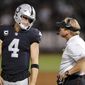 Oakland Raiders quarterback Derek Carr (4) talks with head coach Jon Gruden during the second half of an NFL football game against the Los Angeles Rams in Oakland, Calif., Monday, Sept. 10, 2018. Los Angeles won the game 33-13. (AP Photo/John Hefti)