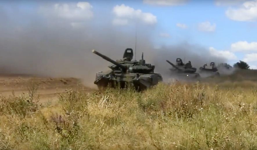 In this photo taken from video provided by Russian Defense Ministry Press Service on Tuesday, Sept. 11, 2018, tanks roll during the military exercises in the Chita region, Eastern Siberia, during the Vostok 2018 exercises in Russia. Russia&#39;s military chief of staff says that the military exercises expected to be the biggest in three decades, will involve nearly 300,000 troops. (Russian Defense Ministry Press Service pool photo via AP)