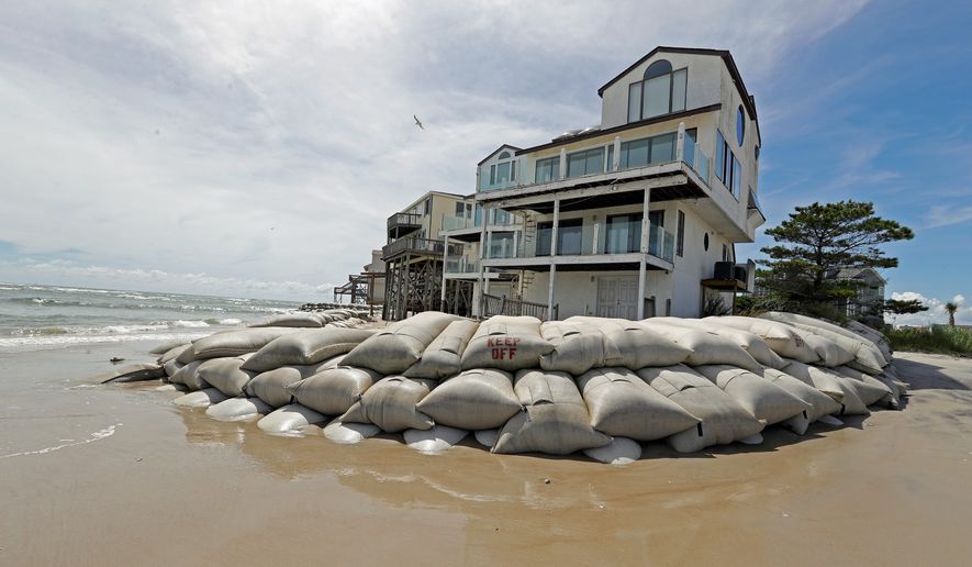 Sand bags surround homes on North Topsail Beach, North Carolina, on Wednesday as Hurricane Florence threatens the coast. As much as 35 inches of rain is expected. (ASSOCIATED PRESS)