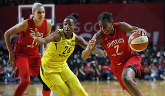 Washington Mystics guard Ariel Atkins (7) drives to the basket as teammate Washington Mystics forward Elena Delle Donne (11) is left and Seattle Storm guard Jewell Loyd (24) defends during the first half of Game 3 of the WNBA basketball finals, Wednesday, Sept. 18 2018, in Fairfax, Va. (AP Photo/Carolyn Kaster)