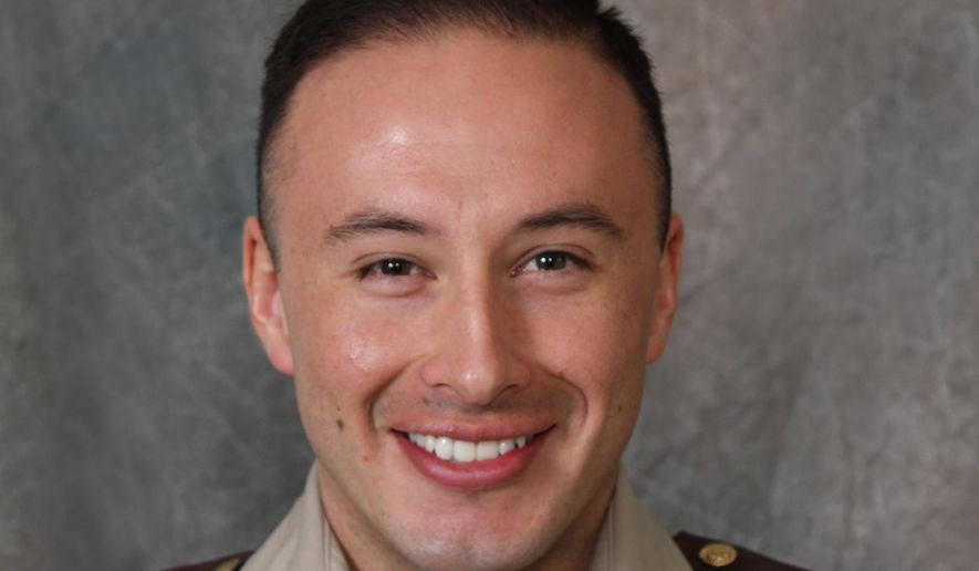 Scott County Deputy Jaime Morales is seen in an undated photo provided by the Scott County Sheriff&#x27;s Office. A Florida bank robbery suspect tracked down at an interstate rest stop in Kentucky late Tuesday was killed in a late-night exchange of gunfire that left Morales critically wounded, authorities said Wednesday, Sept. 12, 2018. The fugitive, Edward Reynolds, died at the rest stop, Kentucky State Police Trooper Bernis Napier said. (Scott County Sheriff&#x27;s Office via AP)