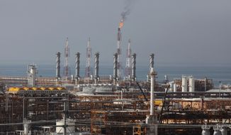 In this Jan. 22, 2014, file photo, a partially constructed gas refinery at the South Pars gas field is seen on the northern coast of Persian Gulf in Asalouyeh, Iran. Iran likely will further embrace Beijing as an alternative market for its crude oil and financial transactions amid uncertainty over the nuclear deal. That doesn’t mean China offers a safe haven to Iran without conditions. Analysts say Beijing will try to extract the maximum benefit, and there is growing concern that China may take advantage of Iran. (AP Photo/Vahid Salemi, File)
