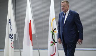 John Coates, chairman of the IOC Coordination Commission for the 2020 Tokyo Olympics and Paralympics leaves from the venue of the IOC and Tokyo 2020 joint press conference Wednesday, Sept. 12, 2018. (AP Photo/Eugene Hoshiko)