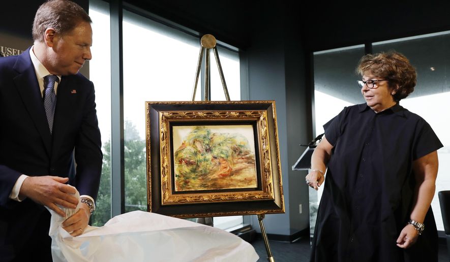United States Attorney Geoffrey Berman, left, unveils a Renoir painting with Sylvie Sulitzer at a news conference, Wednesday, Sept. 12, 2018, in New York. The 1919 oil painting &amp;quot;Femmes Dans Un Jardin&amp;quot; was seized in Paris by the Nazis from Sulitzer&#x27;s grandfather. It was returned to Sulitzer, a delicatessen owner from the south of France, in the ceremony. (AP Photo/Mark Lennihan)
