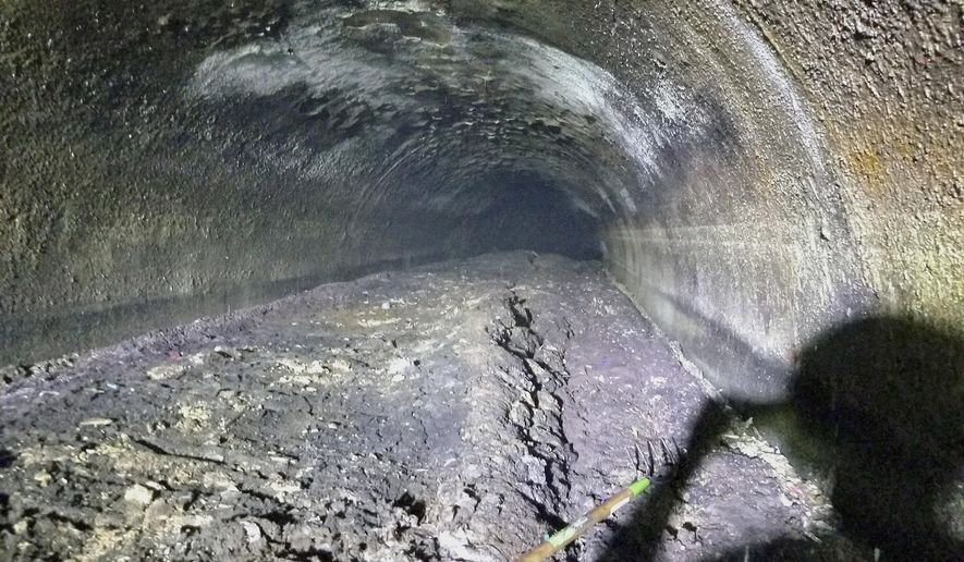 This Sept. 6, 2018 photo provided by the Macomb County Public Works Office shows a large fatberg in a sewer line in Clinton Township, Mich. The Macomb County Public Works Office says workers cleared the 11-foot-diameter pipe that was partially clogged by the collection of oils, grease, fat and solid items such as baby wipes. Officials hope the discovery of the fatberg will help educate the public about what shouldn't go down the drain. (Macomb County Public Works Office via AP)