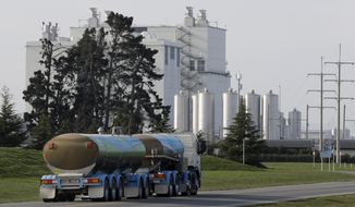 In this Sept. 12, 2018, file photo, a Fonterra milk tanker drives into the Darfield factory near Christchurch, New Zealand.  New Zealand&#39;s largest company, which sells dairy products, said Thursday, Sept. 13,  it will completely review its business investments after a disastrous financial year saw it post its first-ever loss.(AP Photo/Mark Baker)