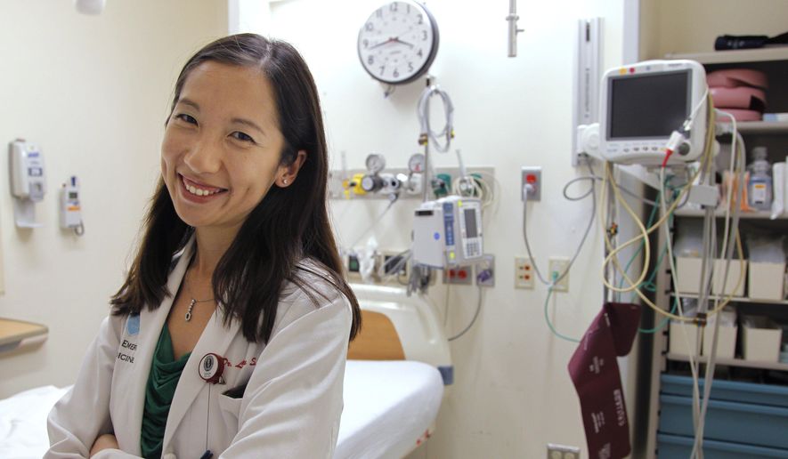 In this Aug. 14, 2012, file photo, Dr. Leana Wen stands in the emergency department at Brigham and Women's Hospital in Boston, during her medical residency. (AP Photo/Steven Senne) ** FILE **
