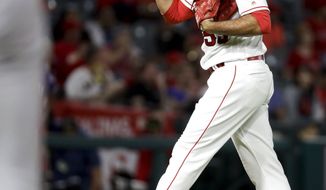 Los Angeles Angels relief pitcher Blake Parker reacts after giving up the first hit of the game to the Texas Rangers during the eighth inning of a baseball game in Anaheim, Calif., Tuesday, Sept. 11, 2018. (AP Photo/Chris Carlson)