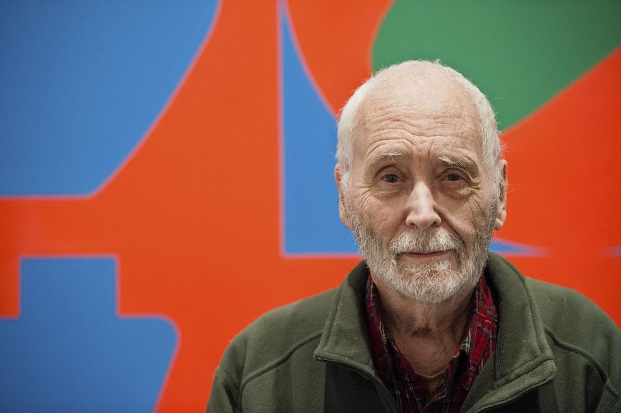 FILE - In this Sept. 24, 2013, file photo, artist Robert Indiana, known for his LOVE artwork, poses in front of that painting at New York's Whitney Museum of American Art. A lawsuit accusing several people of taking advantage of Indiana before his death must be sorted out before the estate can proceed with plans for a museum showing his artwork. On Wednesday, Sept. 12, 2018, attorneys for the pop artist questioned those close to Indiana about his assets, now valued at $60 million. (AP Photo/Lauren Casselberry, File)