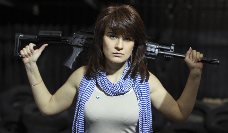 In this Sunday, April 22, 2012, file photo, Maria Butina, a gun-rights activist, poses for a photo at a shooting range in Moscow, Russia. (AP Photo/Pavel Ptitsin, File)