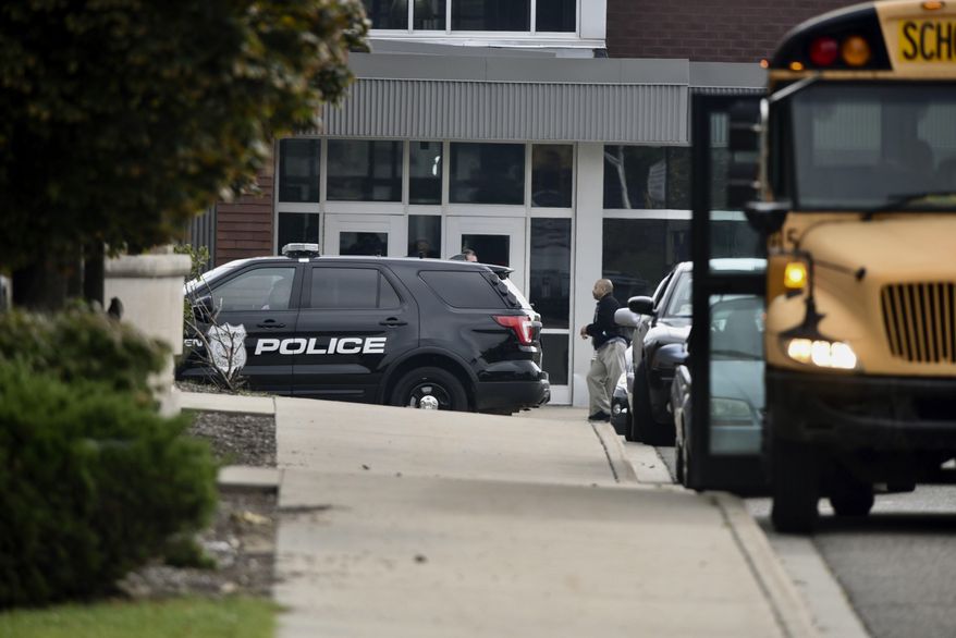 Warren Police patrol Warren Fitzgerald High School after a student was stabbed at the school, on Wednesday, Sept. 12, 2018, in Warren, Mich. (Max Ortiz/Detroit News via AP)