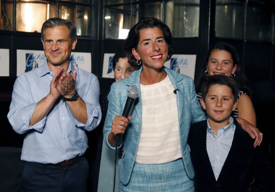 Incumbent Democratic Rhode Island Gov. Gina Raimondo speaks to supporters, alongside her husband Andrew Moffit, left, and children, Thompson and Cecilia, at her primary night victory party, Wednesday, Sept. 12, 2018, in Providence, R.I. (AP Photo/Elise Amendola)