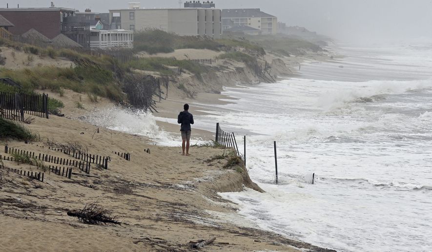 Heavy surf crashes the dunes at high tide in Nags Head, N.C., Thursday, Sept. 13, 2018 as Hurricane Florence approaches the east coast. (AP Photo/Gerry Broome)