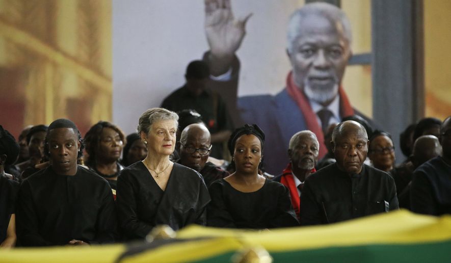 Kofi Annan's son Kojo Annan, left, widow Nane Annan, 2nd left, and daughter Ama Annan, center, join other family members to pay their respects as the coffin of former U.N. Secretary-General Kofi Annan lies in state at the Accra International Conference Center in Ghana Wednesday, Sept. 12, 2018. Ghanaians are paying their respects to Annan, who died in August in Switzerland at age 80, ahead of Thursday's state funeral. (AP Photo/Sunday Alamba)
