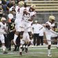 Boston College&#39;s Hamp Cheevers (4) and Brandon Sebastian (10) celebrate Cheevers&#39; interception during the first half of an NCAA college football game against Wake Forest, Thursday, Sept. 13, 2018, in Winston-Salem, N.C. (AP Photo/Woody Marshall)
