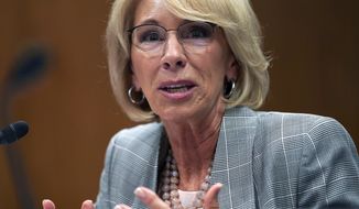 FILE - In this June 5, 2018, file photo, Education Secretary Betsy DeVos testifies during hearing on the FY19 budget on Capitol Hill in Washington. A federal court has ruled that a decision by DeVos to delay an Obama-era rule meant to protect students swindled by for-profit colleges was “arbitrary and capricious,” dealing a significant blow to the Trump administration’s attempt to ease regulations for the industry.   (AP Photo/Carolyn Kaster, File)