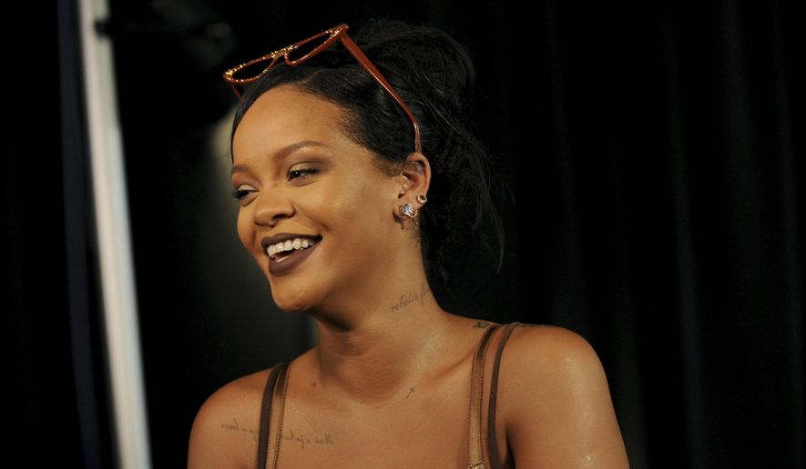Rihanna talks to media backstage after Savage X Fenty fashions are shown in a performance at the Brooklyn Navy Yard at the end of Fashion Week, Wednesday Sept. 12, 2018, in the Brooklyn borough of New York. Rihanna unleashed the wild beast in a lush tropical land to debut her second season of Savage x Fenty lingerie and loungewear. (AP Photo/Diane Bondareff) ** FILE **