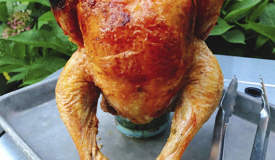 This Aug. 31, 2018 photo shows beercan chicken in Amagansett, N.Y. This dish is from a recipe by Elizabeth Karmel. (Elizabeth Karmel via AP)