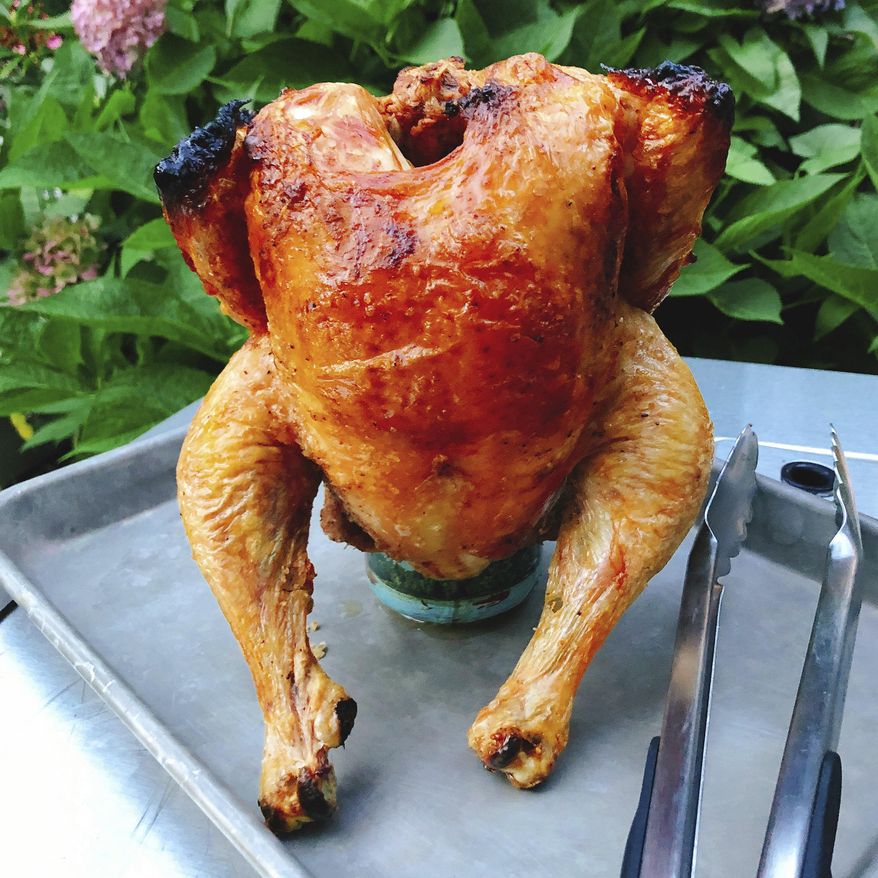 This Aug. 31, 2018 photo shows beercan chicken in Amagansett, N.Y. This dish is from a recipe by Elizabeth Karmel. (Elizabeth Karmel via AP)