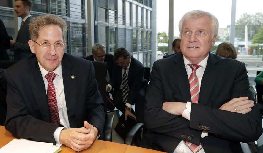 Hans-Georg Maassen, left, head of the German Federal Office for the Protection of the Constitution, and German Interior Minister Horst Seehofer, right, arrive for a hearing at the home affairs committee of the German federal parliament, Bundestag, in Berlin, Germany, Wednesday, Sept. 12, 2018. (AP Photo/Michael Sohn)