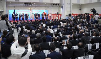 Tokyo Governor Yuriko Koike, rear center, leads opening ceremony for new site of Tokyo&#39;s fish market which will officially open to the public next month, in Tokyo Thursday, Sept. 13, 2018. Tokyo&#39;s hugely popular Tsukiji fish market will be closed for up to five years while it is modernized and turned into a food theme park. The fish market&#39;s move to Toyosu was originally scheduled for last year but has been delayed due to contamination of underground water at the new complex. (AP Photo/Eugene Hoshiko)