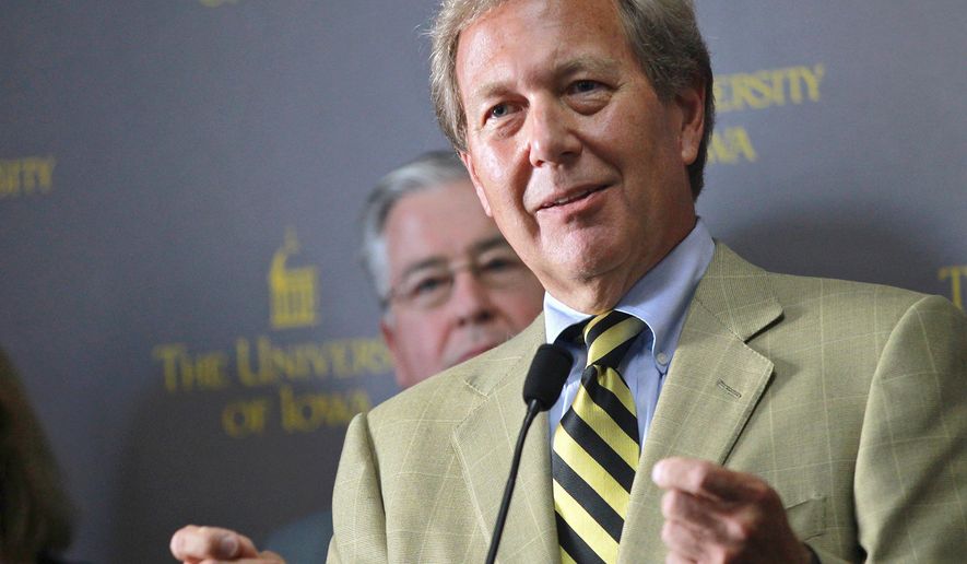 FILE - In this Sept. 3, 2015, file photo, Bruce Harreld speaks to media after he was introduced as the new University of Iowa president during a news conference in Iowa City, Iowa. The university has agreed to pay $55,000 to settle a lawsuit alleging that its 2015 presidential search violated the open meetings law. The university doesn&#39;t admit any violations in the settlement, which was made public Wednesday, Sept. 12, 2018. But Iowa has agreed to abide by several transparency measures during future presidential searches. (David Scrivner/Iowa City Press-Citizen via AP, File)