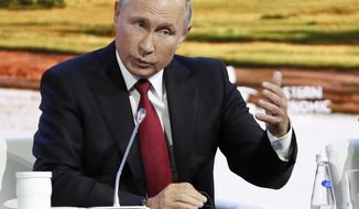 Russian President Vladimir Putin gestures as he speaks during a plenary session at the Eastern Economic Forum in Vladivostok, Russia, Wednesday, Sept. 12, 2018. Putin says Russia has identified the two men that Britain named as suspects in the poisoning of a former Russian spy and that there is &amp;quot;nothing criminal&amp;quot; about them. (AP Photo/Dmitri Lovetsky)