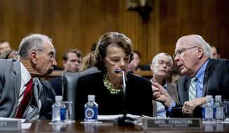 Senate Judiciary Committee Chairman Chuck Grassley, R-Iowa, left, accompanied by Sen. Dianne Feinstein, D-Calif., the ranking member, center, speaks with Sen. Patrick Leahy, D-Vt., right, during a Senate Judiciary Committee markup meeting on Capitol Hill, Thursday, Sept. 13, 2018, in Washington. The committee will vote next week on whether to recommend President Donald Trump&#39;s Supreme Court nominee, Brett Kavanaugh for confirmation. Republicans hope to confirm him to the court by Oct. 1.(AP Photo/Andrew Harnik)